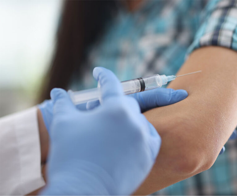 Healthcare worker gives vaccine