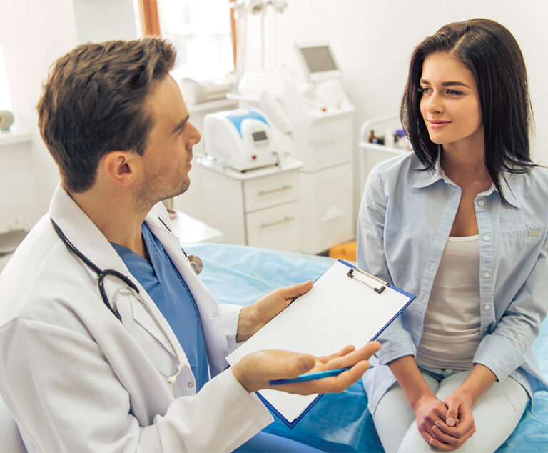 Male physician counseling female patient.