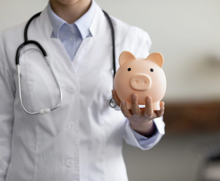 Photo of healthcare provider holding piggy bank