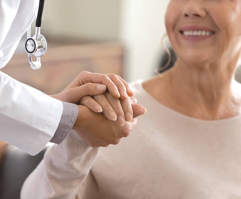 Doctor comforting cancer patient