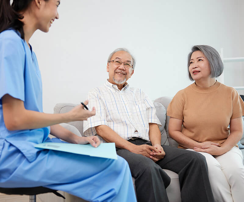 Doctor discussing RSV vaccine benefits with senior couple