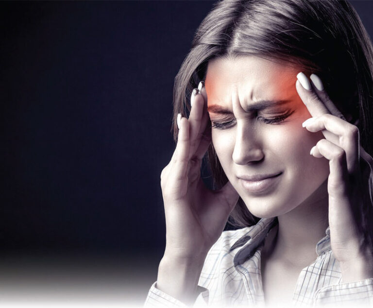 woman with headache rubbing temples