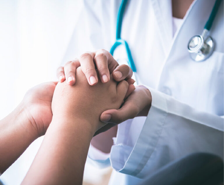 Photo of physician holding patient's hands