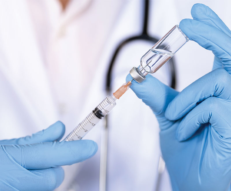 Healthcare worker filling a syringe