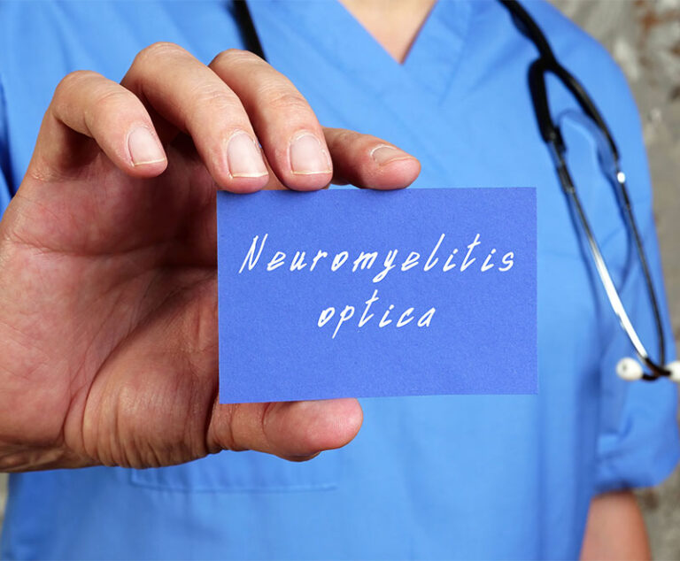 healthcare worker with sign that says neuromyelitis optica