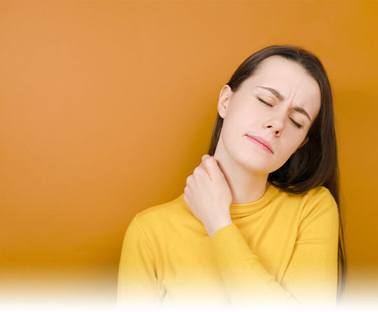 Woman holding her shoulder in pain