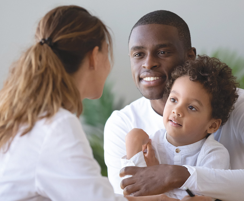 pediatric patient and father talking to doctor