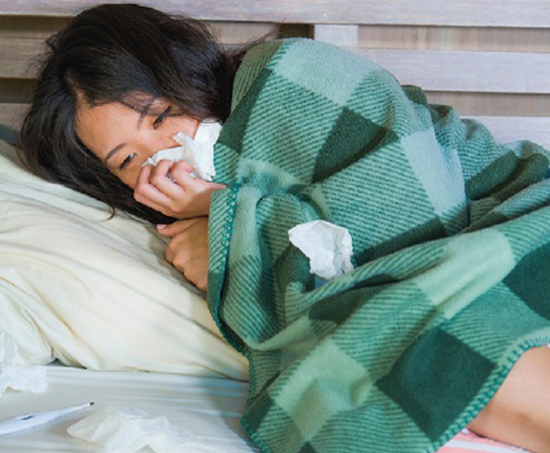 young girl with virus curled up in blanket