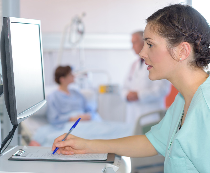 Photo of healthcare worker reading computer screen