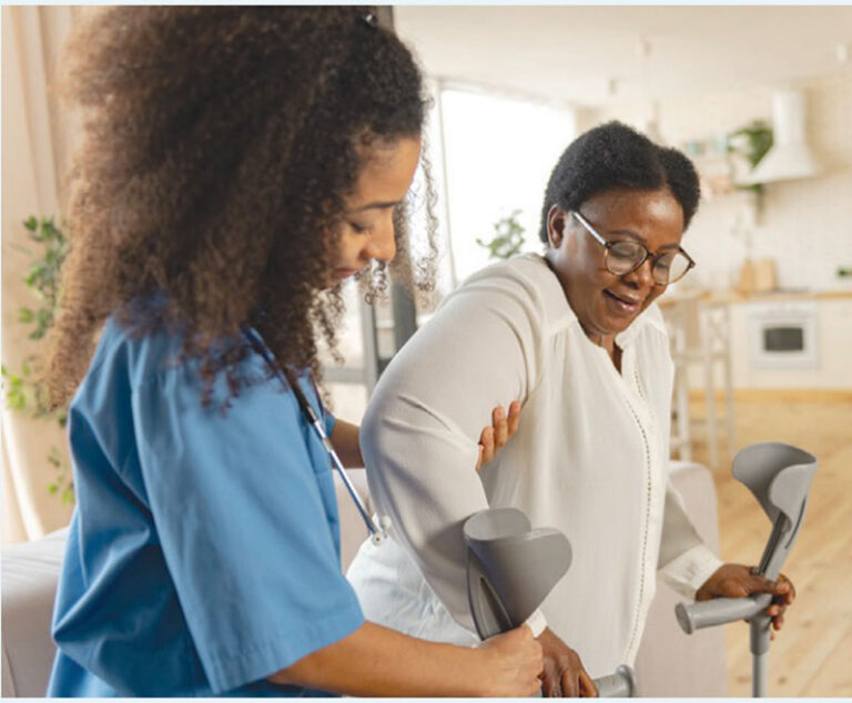 nurse helping patient use forearm crutches