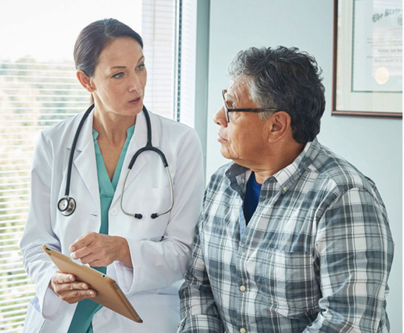 Physician speaking to an adult male patient