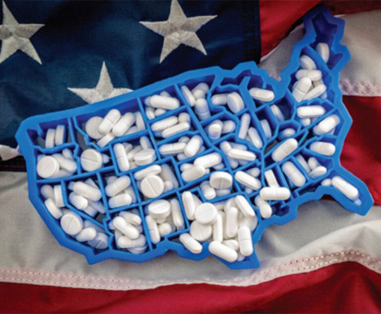 Image of American flag with prescription pills in a U.S.-shaped pill divider