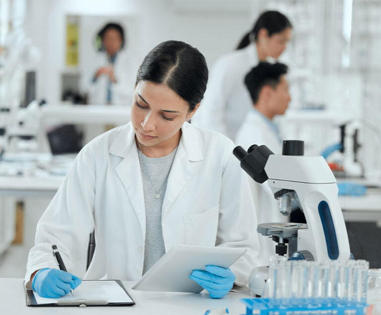 Photo of a female medical researcher recording data