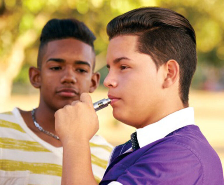 Photo of teen using an e-cigarette