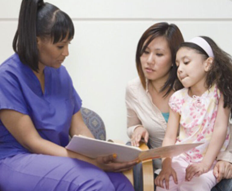 Photo of healthcare provider showing information to mother and child